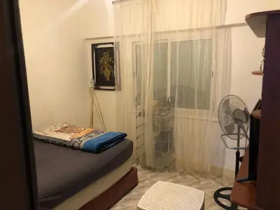 a small room with a bed and a fan at ÉTABLISSEMeNT BEAU SÉJOUR in Marrakech
