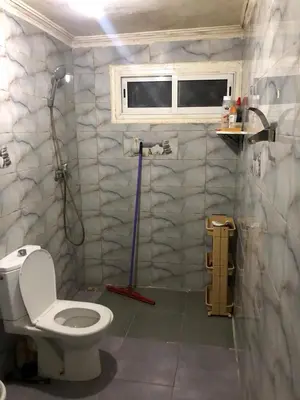 a bathroom with a toilet and a shower in it at ÉTABLISSEMeNT BEAU SÉJOUR in Marrakech