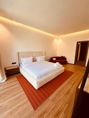 a bedroom with a white bed and a red rug at Villa Tiffany NORIA GOLF in Marrakech