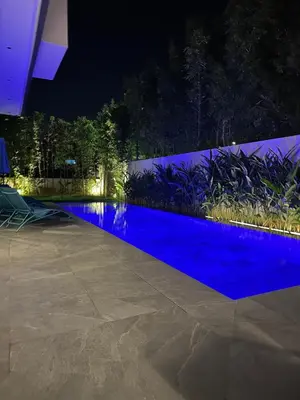 a swimming pool at night with blue water at Villa Tiffany NORIA GOLF in Marrakech
