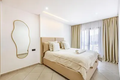 a bedroom with a large bed with a mirror on the wall at Modern & cozy apartment in Marrakech