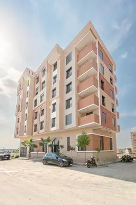 a large building with a car parked in front of it at Modern & cozy apartment in Marrakech