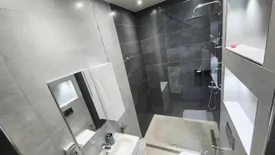 a bathroom with a shower and a toilet and a sink at Villa with private pool in Marrakech