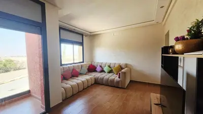 a living room with a couch and a window at Villa with private pool in Marrakech