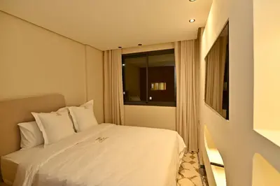 a bedroom with a white bed and a window at Luxurious colorful apartment in Marrakech