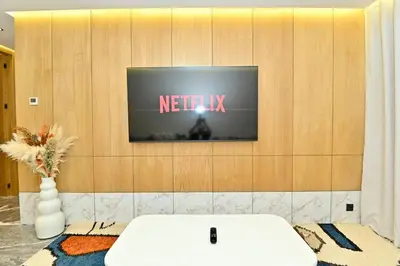 a tv on a wall with a netflix sign on it at Luxurious colorful apartment in Marrakech