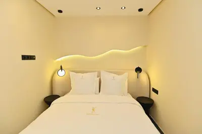 a bedroom with a large white bed with two pillows at Luxurious colorful apartment in Marrakech