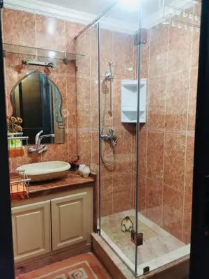 a bathroom with a shower and a sink at Air Conditioned Appartment across YSL Museum in Marrakech
