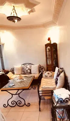 a living room with a couch and a table at Air Conditioned Appartment across YSL Museum in Marrakech