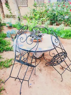 a table with a cat sitting on top of it at Air Conditioned Appartment across YSL Museum in Marrakech