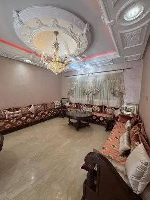 a living room with a couch and a chandelier at Villa avec piscine privé in Marrakech