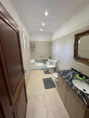 a bathroom with a sink and a toilet and a mirror at Villa avec piscine privé in Marrakech