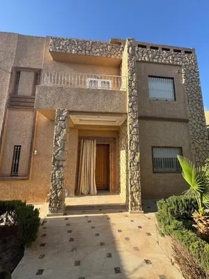 a large building with a door and a balcony at Villa avec piscine privé in Marrakech