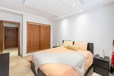 a bedroom with a large bed and a window at La Perle - Semlalia Gueliz - 2 Prs - Balcony in Marrakech