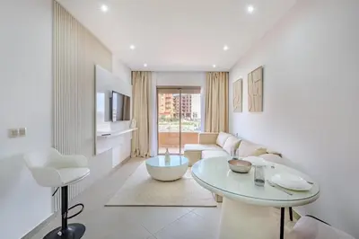 a living room with a table and a couch at Appartement chic près de la gare in Marrakech