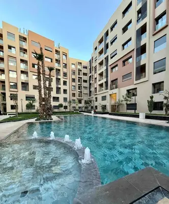 a swimming pool in front of some apartment buildings at TERRASSE, 2 CHAMBRES SPACIEUSES, 6 COUCHAGES, 2 PiSCINES, PARKING, IDÈAL FAMILLE in Marrakech