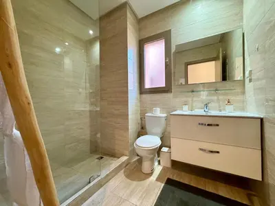 a bathroom with a toilet and a sink and a shower at RESIDENCE PRESTIGIA, Piscine, calme et verdure in Marrakech