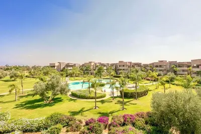 an aerial view of a resort with a swimming pool at RESIDENCE PRESTIGIA, Piscine, calme et verdure in Marrakech