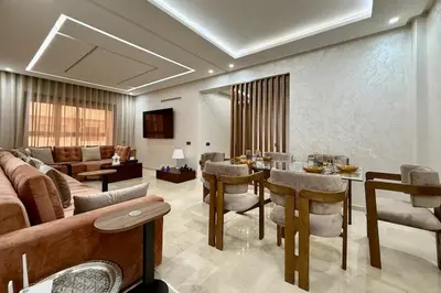 a living room with a table and a couch at Two Bedroom Apartment with Pool in Marrakech