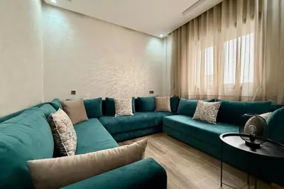 a living room with a blue couch and a table at Two Bedroom Apartment with Pool in Marrakech