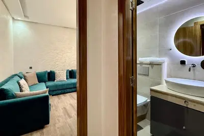 a bathroom with a sink and a couch in a room at Two Bedroom Apartment with Pool in Marrakech