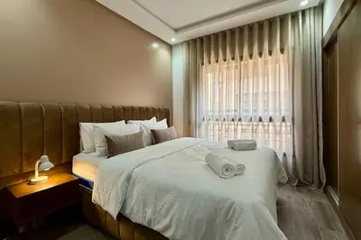 a bedroom with a large bed and a window at Two Bedroom Apartment with Pool in Marrakech