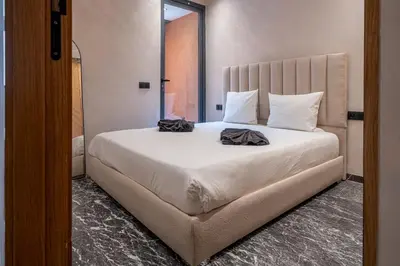 a bedroom with a large white bed with two pillows at appartement Confort & modernité au centre de Marrakech in Marrakech