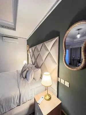 a bedroom with a bed with a mirror and a lamp at Complexe villa and Restaurant in Marrakech