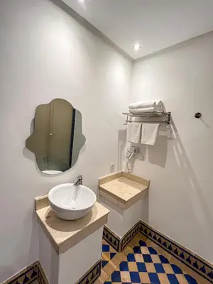 a bathroom with a sink and a mirror on the wall at Complexe villa and Restaurant in Marrakech