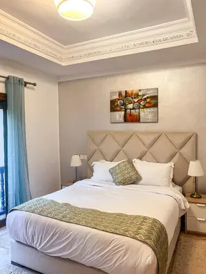 a bedroom with a large bed in a room at Complexe villa and Restaurant in Marrakech