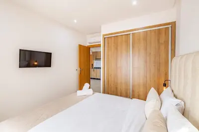a bedroom with a bed and a sliding door at Nouvel 1 chambre proche centre in Marrakech