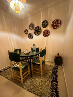 a dining room with a table and plates on the wall at A flat near the airport in Marrakech