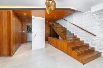 a staircase in a house with wood and stone at Villa Anzar Refined Oasis wChef and Emerald Hammam in El Rhechat
