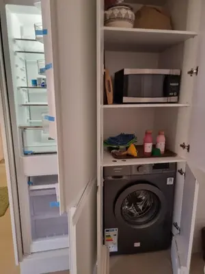 a closet with a washing machine and a microwave at Bohemian & Moroccan Apartment Close to Airport & Medina in Marrakech