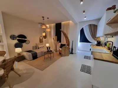 a large living room with a bed and a couch at Bohemian & Moroccan Apartment Close to Airport & Medina in Marrakech