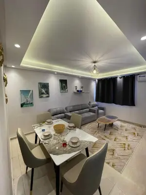 a living room with a table and a couch at Vivez le rêve dans un appartement F4 moderne in Marrakech