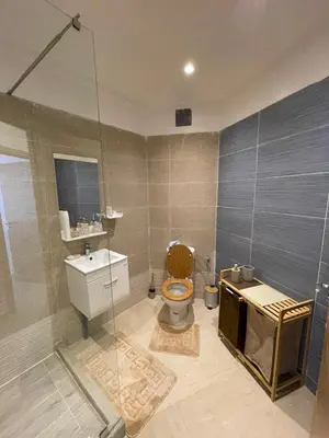 a bathroom with a toilet and a glass shower at Vivez le rêve dans un appartement F4 moderne in Marrakech