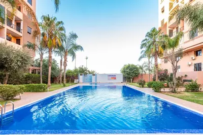 a large blue swimming pool in front of a building at Apartment with swimming pool in Marrakech