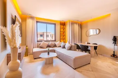 a living room with a couch and a table at Apartment with swimming pool in Marrakech