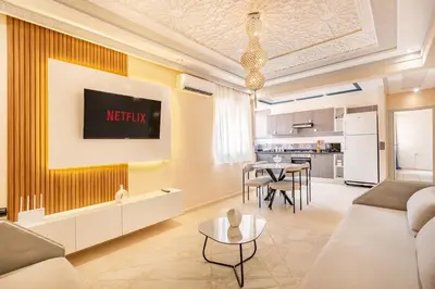 a living room with a couch and a table at 2 chambres dans la ville rouge in Douar Bellouk
