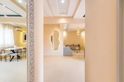 a room with a table and a dining room at 2 chambres dans la ville rouge in Douar Bellouk