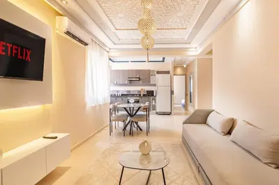 a living room with a couch and a table at 2 chambres dans la ville rouge in Douar Bellouk