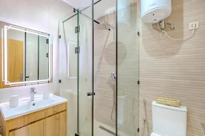 a bathroom with a shower and a toilet and a sink at Escapade intime en ville rouge in Marrakech