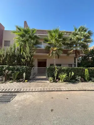a house with palm trees in front of it at Villa 4 Suites with Pool, near Hivernage in Marrakech