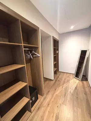 an empty closet with wooden shelves in a room at Villa 4 Suites with Pool, near Hivernage in Marrakech