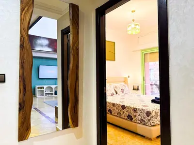 a bedroom with a bed and a mirror at Gueliz 3BR 3BA Duplex Pool & Balcony Majorelle in Marrakech