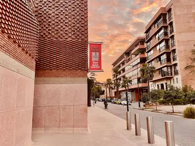 a red sign on the side of a building on a street at Gueliz 3BR 3BA Duplex Pool & Balcony Majorelle in Marrakech