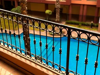 a fence next to a swimming pool at Gueliz 3BR 3BA Duplex Pool & Balcony Majorelle in Marrakech