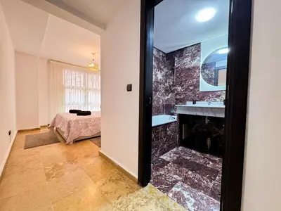 a living room with a fireplace and a bedroom at Gueliz 3BR 3BA Duplex Pool & Balcony Majorelle in Marrakech
