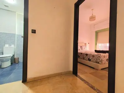 a mirror in a room with a bed and a bathroom at Gueliz 3BR 3BA Duplex Pool & Balcony Majorelle in Marrakech